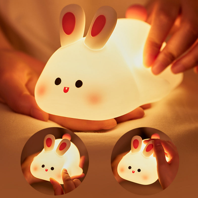 Sleepy Rabbit illuminated in a hand, showing its touchable silicone form