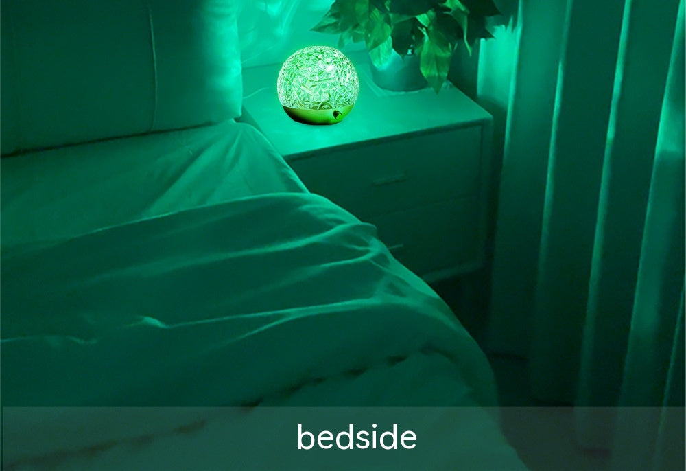 Ripple Glow crystal sphere on a bedside table with coloured ripple light