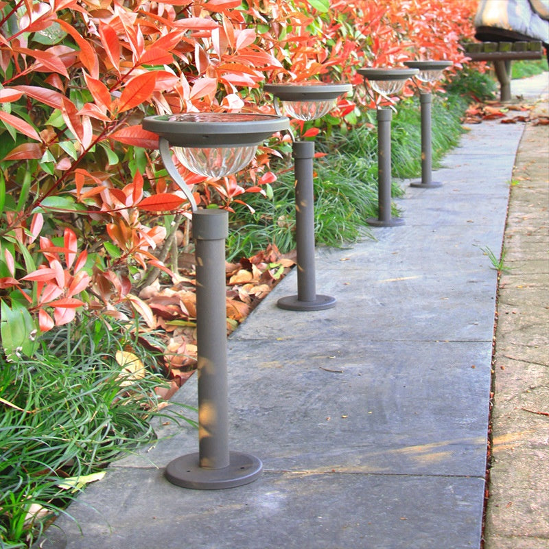 Arc solar garden lights beside a path in daylight; sold individually